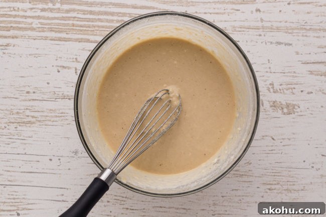 Whisking pancake batter in a bowl.