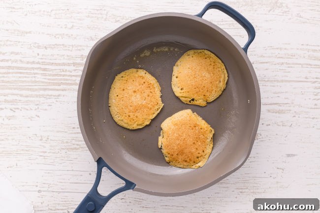 Frying three pancakes in a non-stick skillet.