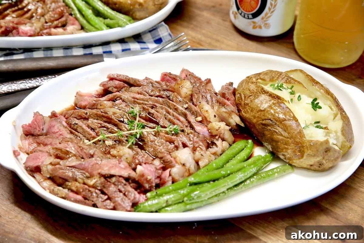 Honey Balsamic Glazed Steak Recipe for Weeknight Dinner 5 Ribeye steak sliced on plate with baked potato and green beans.