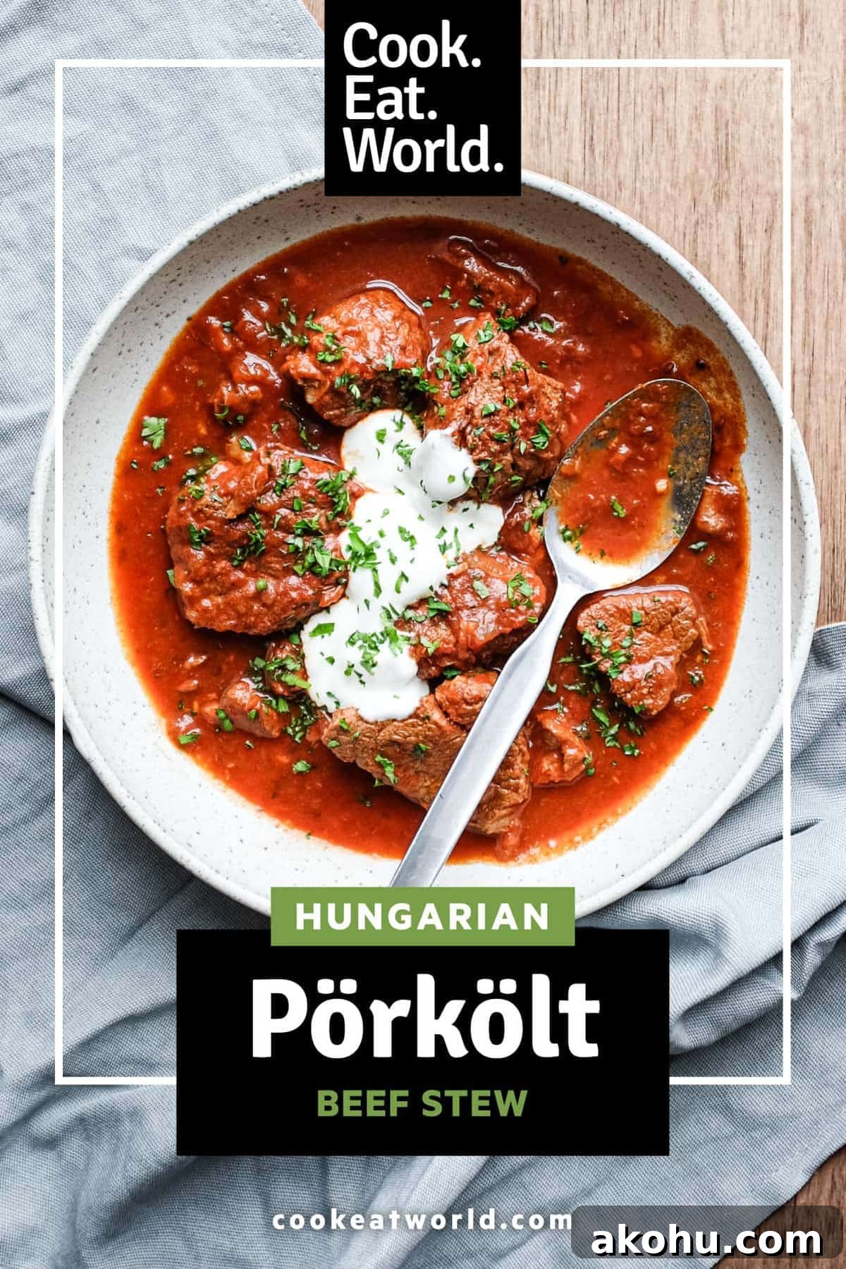 A bowl of Hungarian Pörkölt Beef Stew in a bowl, wrapped in a tea towel.