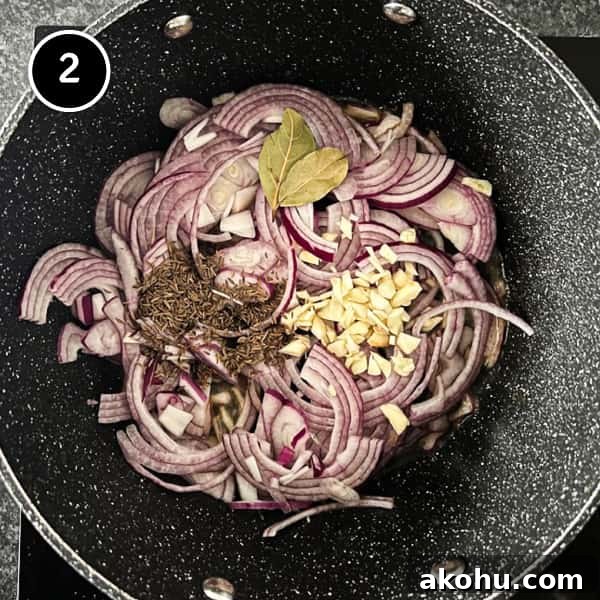 Onion, garlic, bay leaves and caraway frying in a large pot