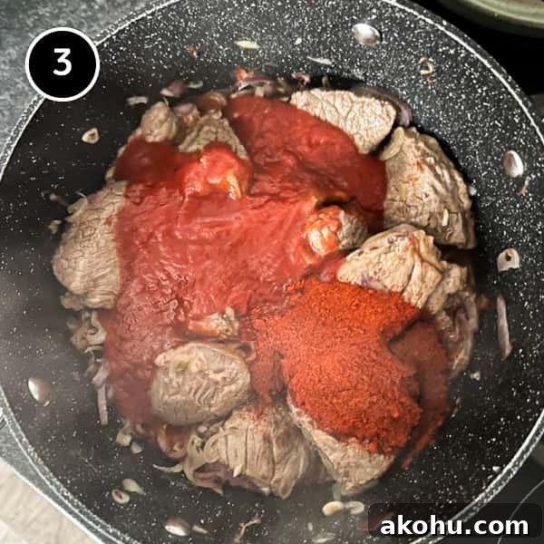 Tomatoes and Paprika being added to the Hungarian Pörkölt Beef Stew