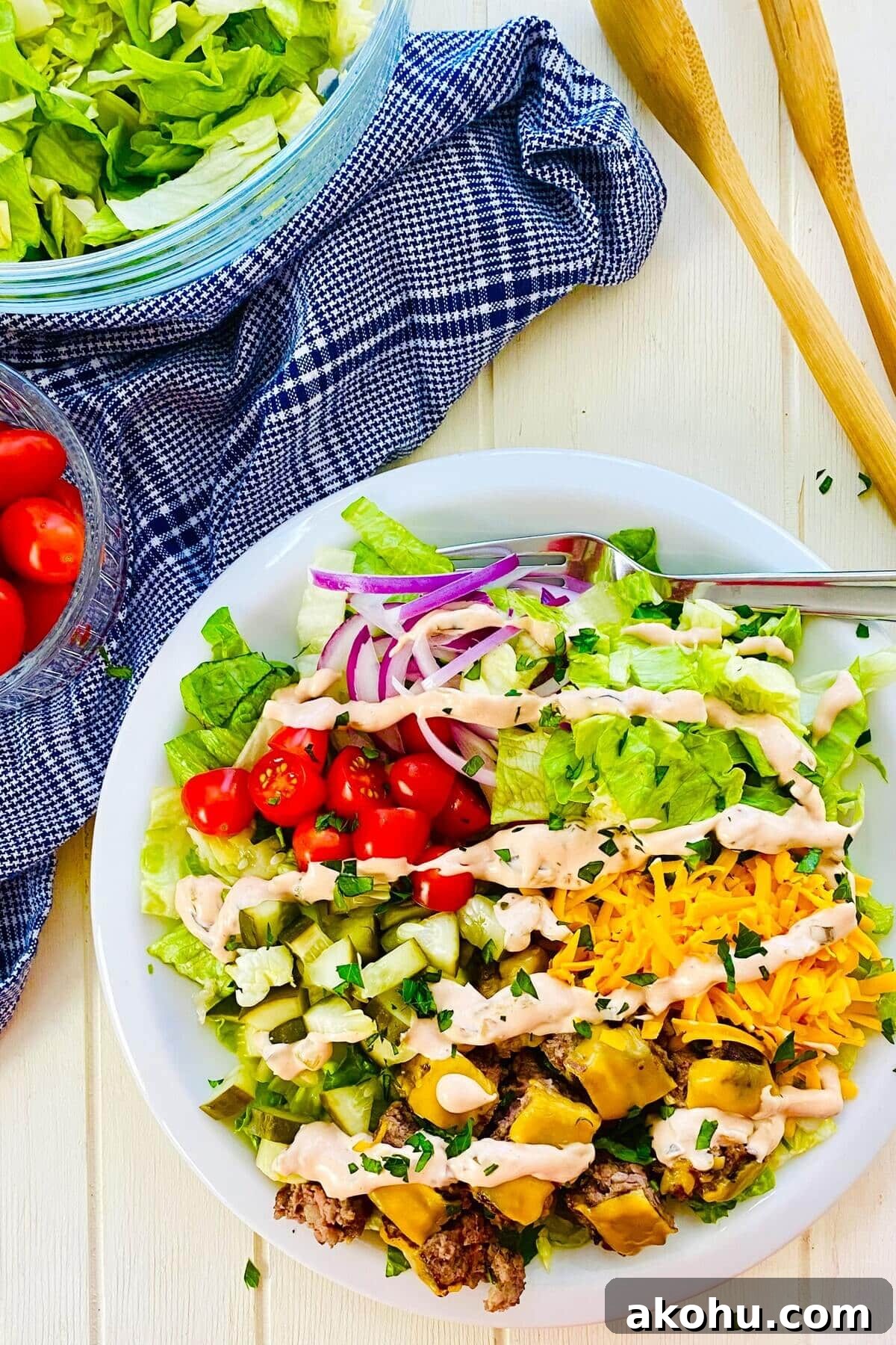 An assembled Big Mac salad bowl with special sauce dressing.