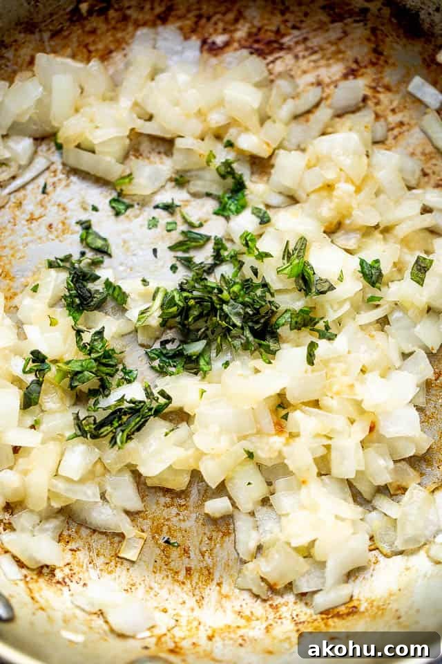 This creamy coconut shrimp recipe is bursting with delicious Thai-inspired flavors and is ready in 20 minutes. cooking chopped onions with fresh herbs