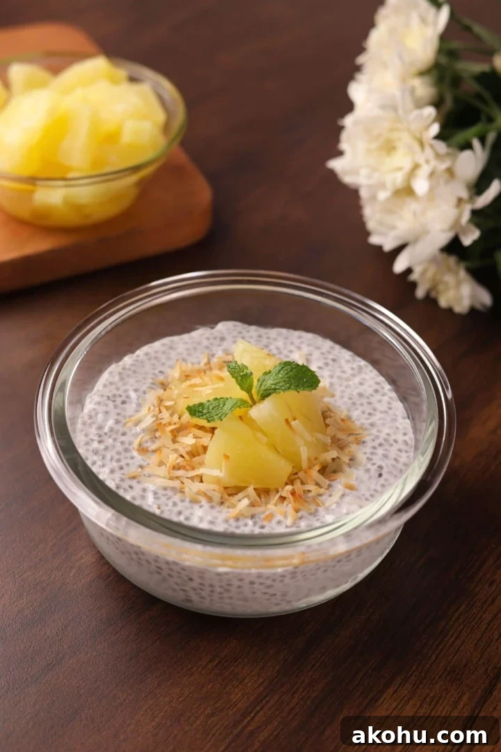 Creamy Coconut Chia Pudding Recipe for a Satisfying Breakfast 2 Creamy coconut chia seed pudding topped with toasted coconut and pineapple chunks in a glass bowl.
