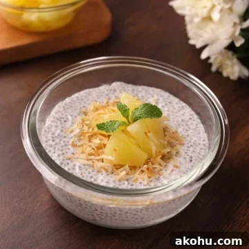 Creamy coconut milk chia seed pudding in a bowl topped with toasted coconut and pineapple.