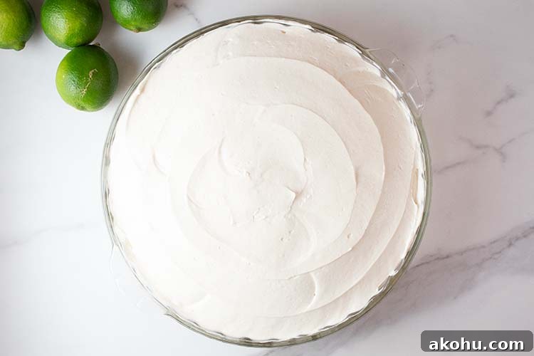 overhead view of keto no bake key lime cheesecake in a glass pie serving dish