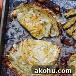 close up of beefy roasted cabbage steaks to show caramelization and seasoningsd