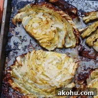 close up of beefy roasted cabbage steaks to show caramelization and seasoningsd