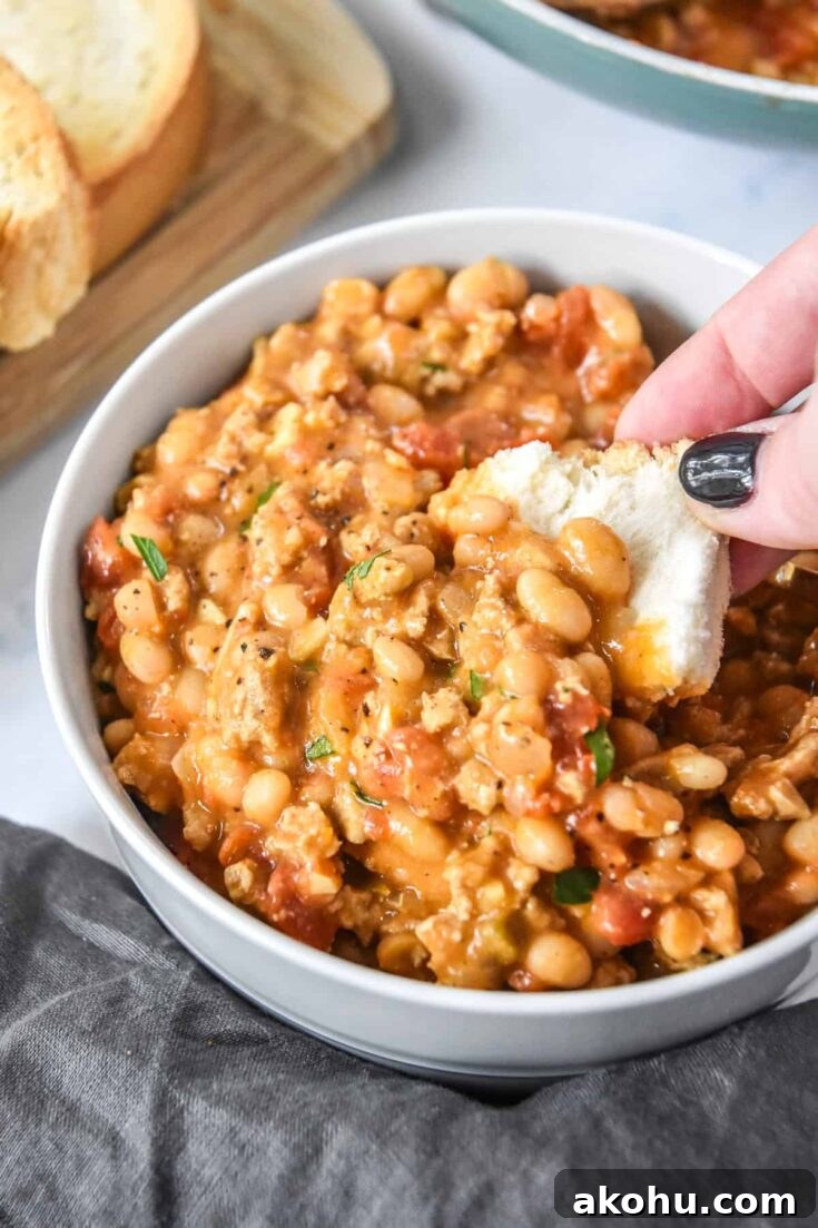 dipping breading into the sloppy ground turkey white bean skillet.