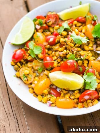 corn, tomatoes and lime in a bowl