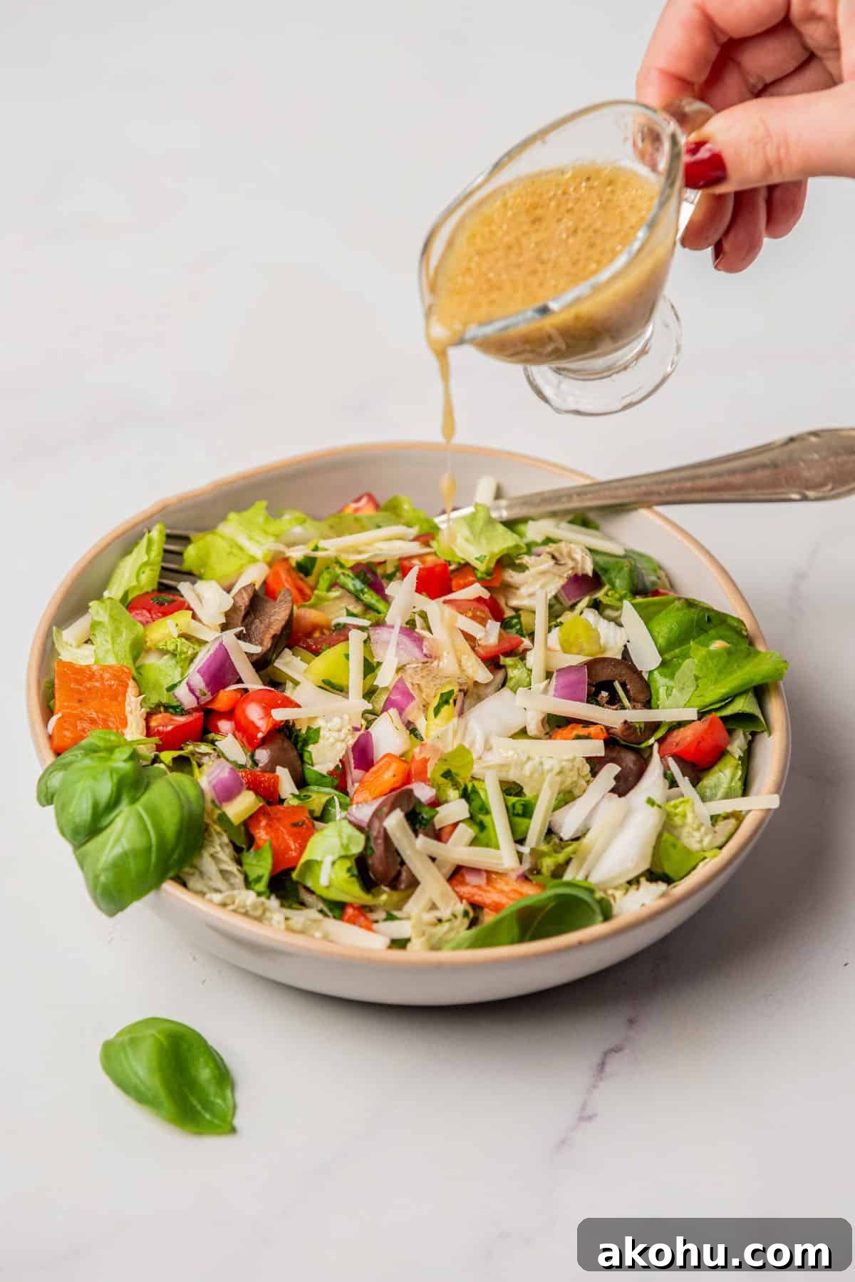 An image of an Italian chopped salad with champagne vinaigrette dressing, in a serving plate.