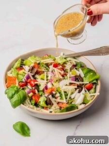 Classic Italian Chopped Salad Recipe with Zesty Dressing 11 An image of an Italian chopped salad with champagne vinaigrette dressing, in a serving plate.