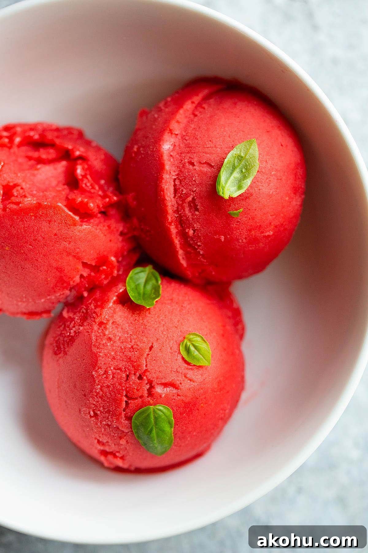 Ninja Creami strawberry sorbet with basil leaves