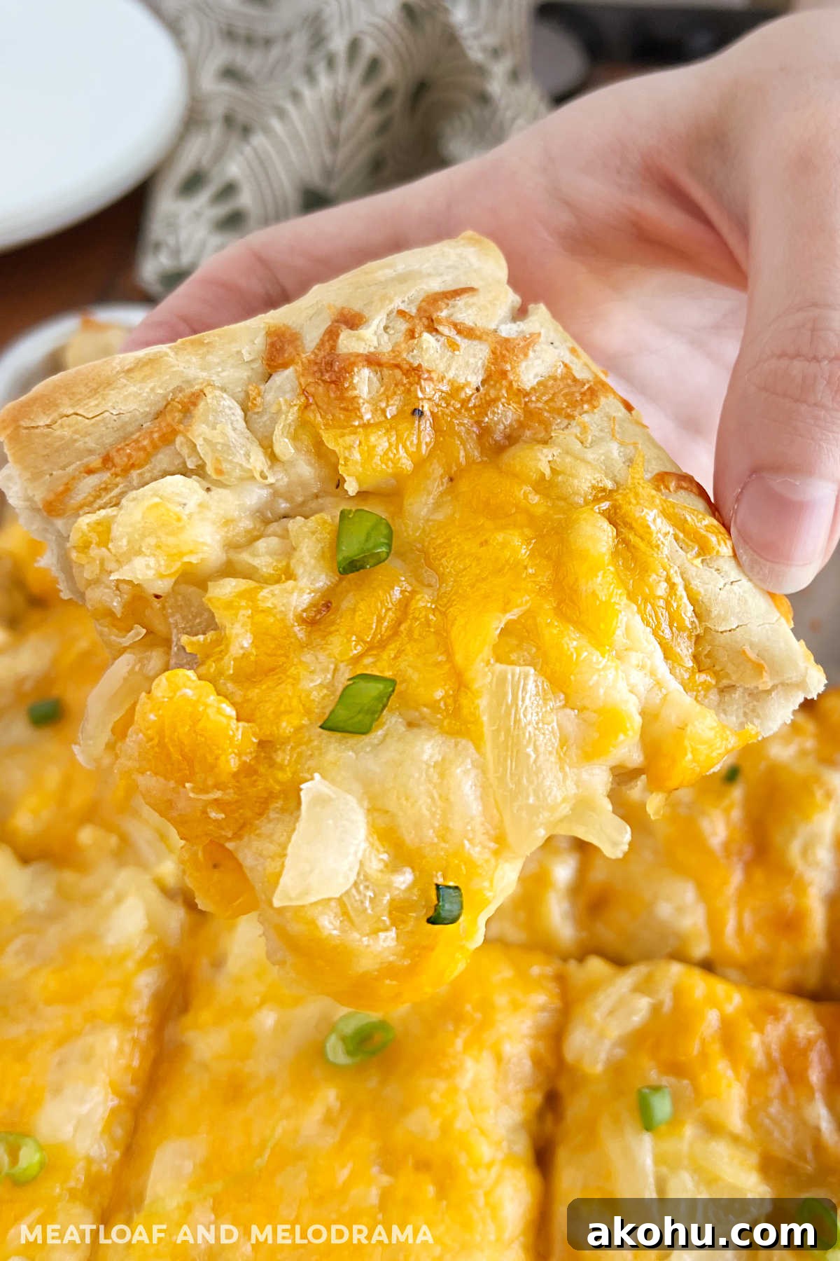 Pierogi Pizza (Pagach) Recipe: Polish Dumpling-Style Pizza 2 slice of pierogi pizza (pagach) with onions in hand