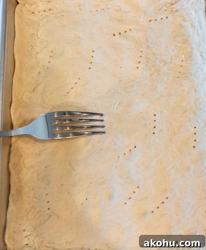 Pierogi Pizza (Pagach) Recipe: Polish Dumpling-Style Pizza 4 poke holes in pizza crust with fork