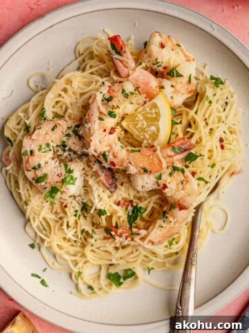 A plate of spaghetti and shrimp scampi.