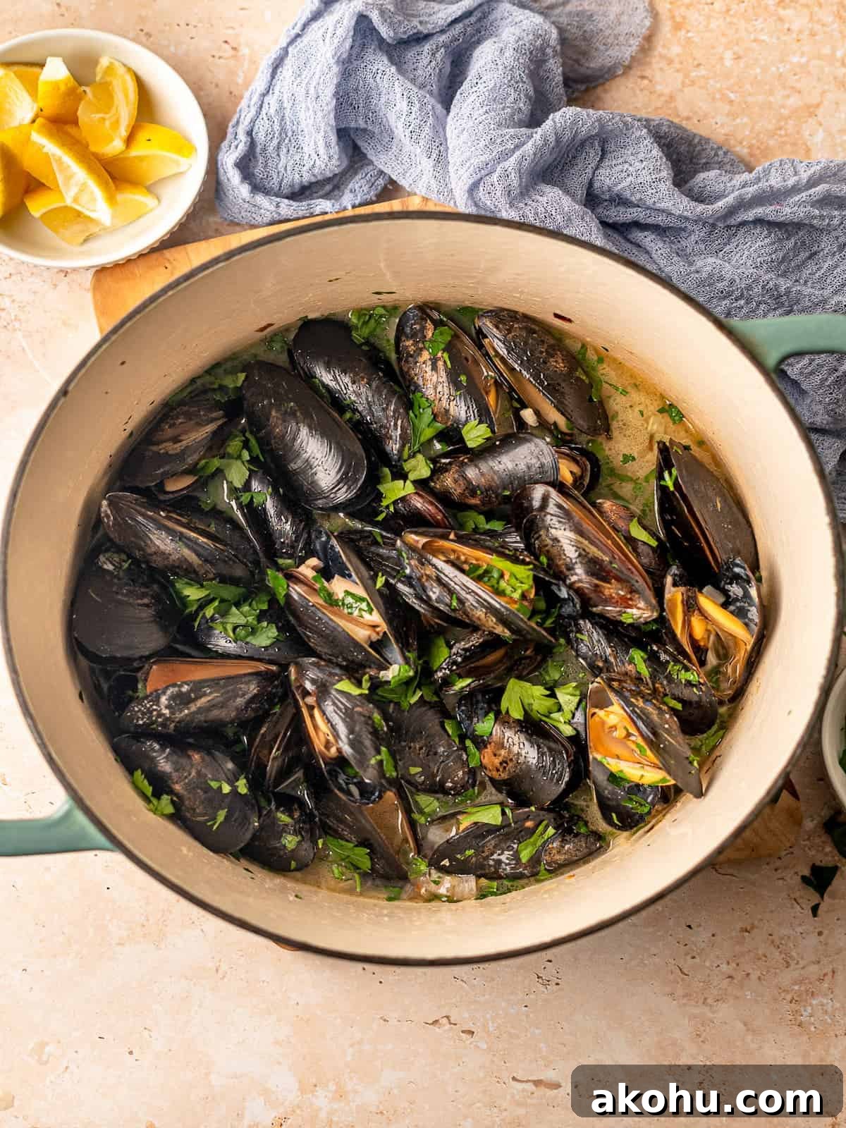 A large pot of mussels in broth.
