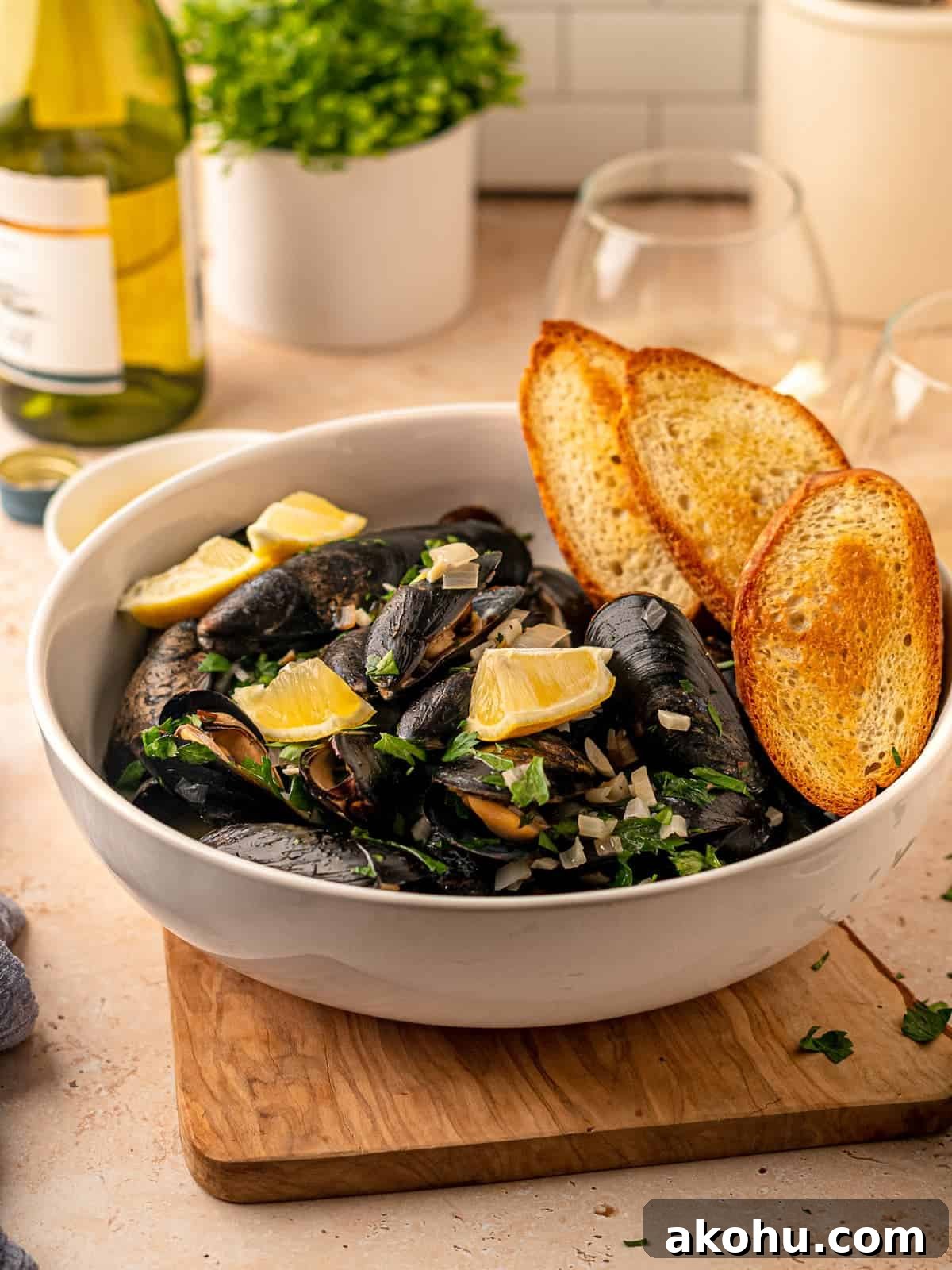 A large bowl of mussels with toasted bread.