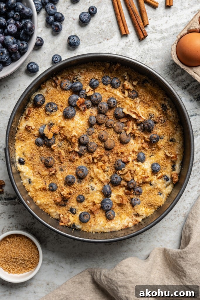 Sprinkling the turbinado sugar, cinnamon, and remaining blueberries on top. 