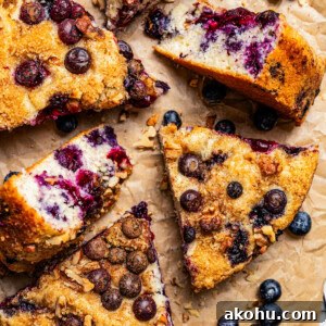 Slices of blueberry cake arranged on brown parchment paper.