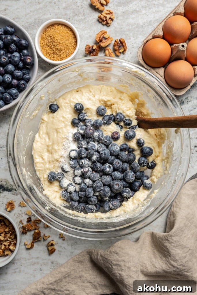 Folding the blueberries into the batter. 