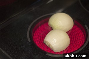 Hearty Beef Soup with Fluffy Semolina Dumplings 2 An onion cut in half on a hot stove plate