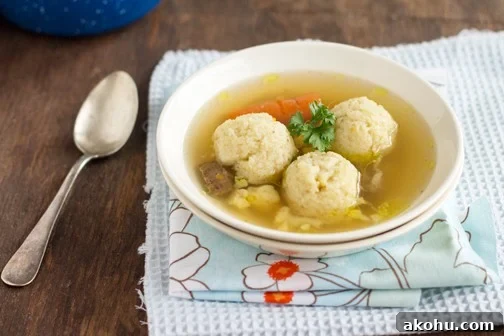 Hearty Beef Soup with Fluffy Semolina Dumplings 7 A bowl of food on a plate on a table