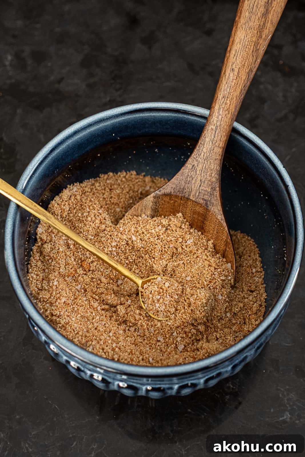 Homemade pork rib spice blend in a bowl with mixing spoons