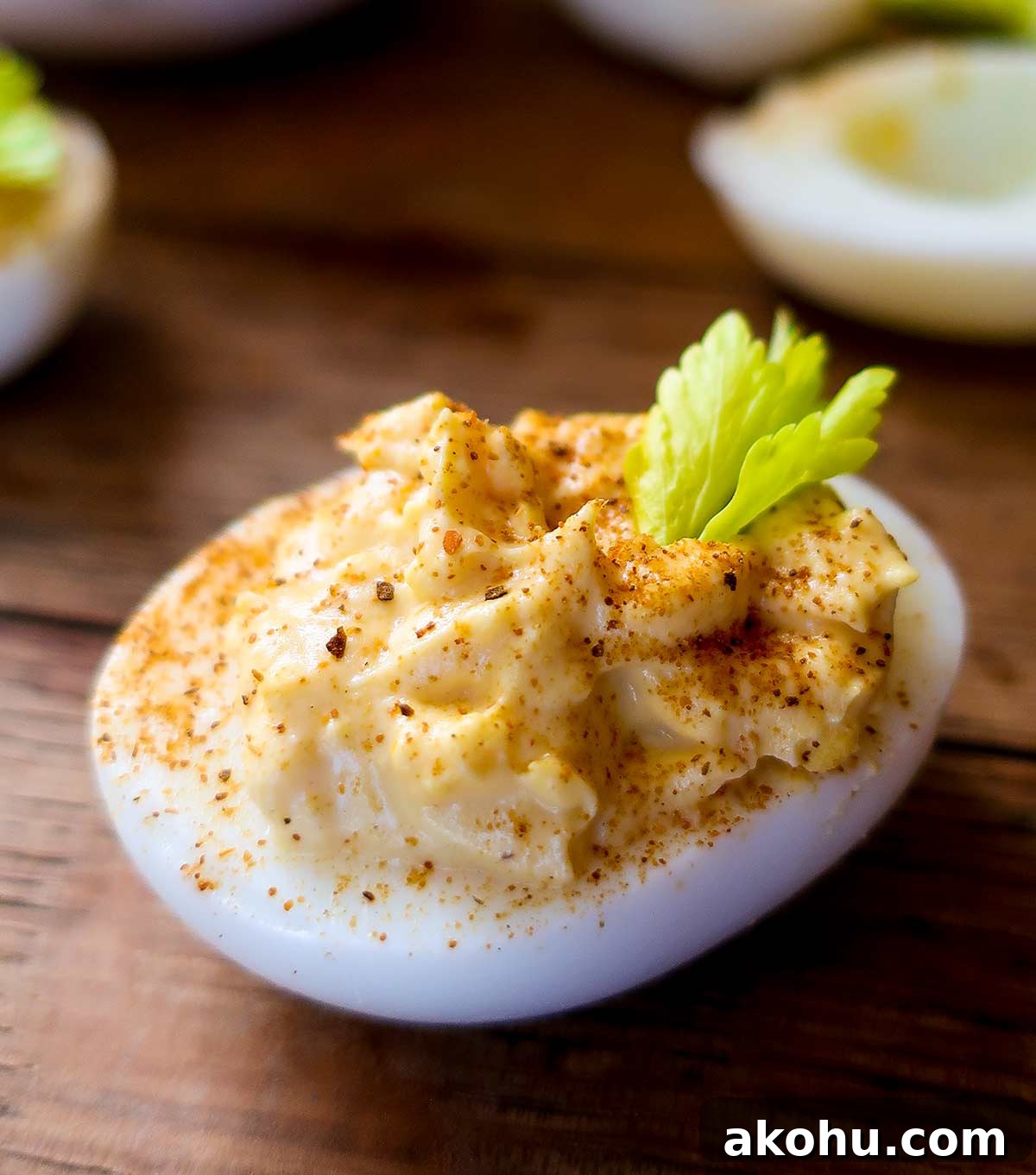 Deviled Eggs: Complete Guide with Top Recipes and Tips 2 classic devilled egg with celery and paprika garnish