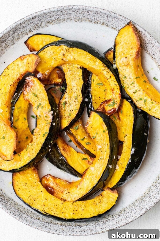 Crispy Air-Fryer Acorn Squash Recipe for Fall Sides 2 A plate showing acorn squash cut into wedges and roasted in an air fryer.