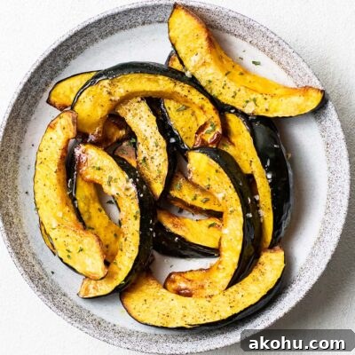 Crispy Air-Fryer Acorn Squash Recipe for Fall Sides 8 A plate of roasted acorn squash sprinkled with coarse sea salt.