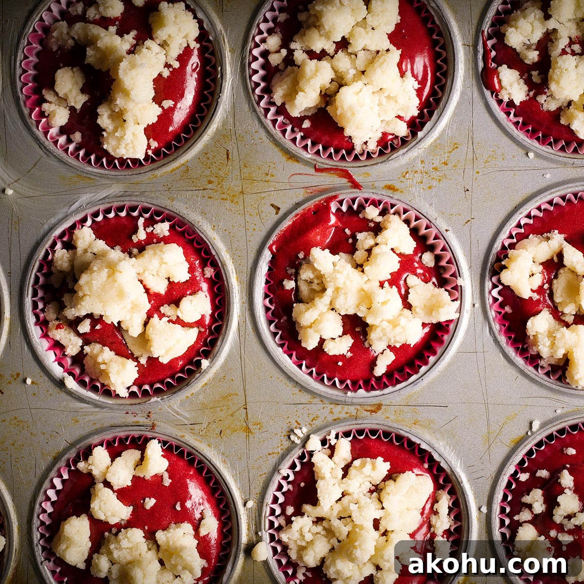 Red Velvet Muffins Filled with Cream Cheese Swirl 16 Top red velvet muffin batter with butter crumb topping before baking.