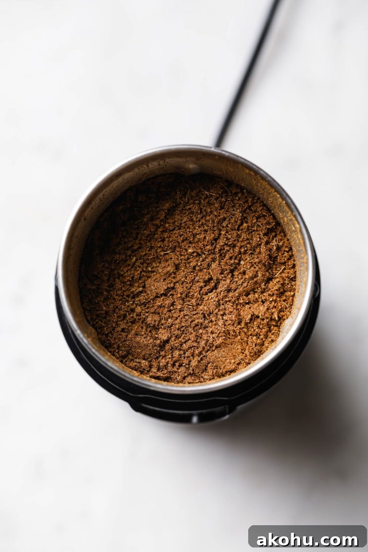 Freshly ground cumin in a spice jar.