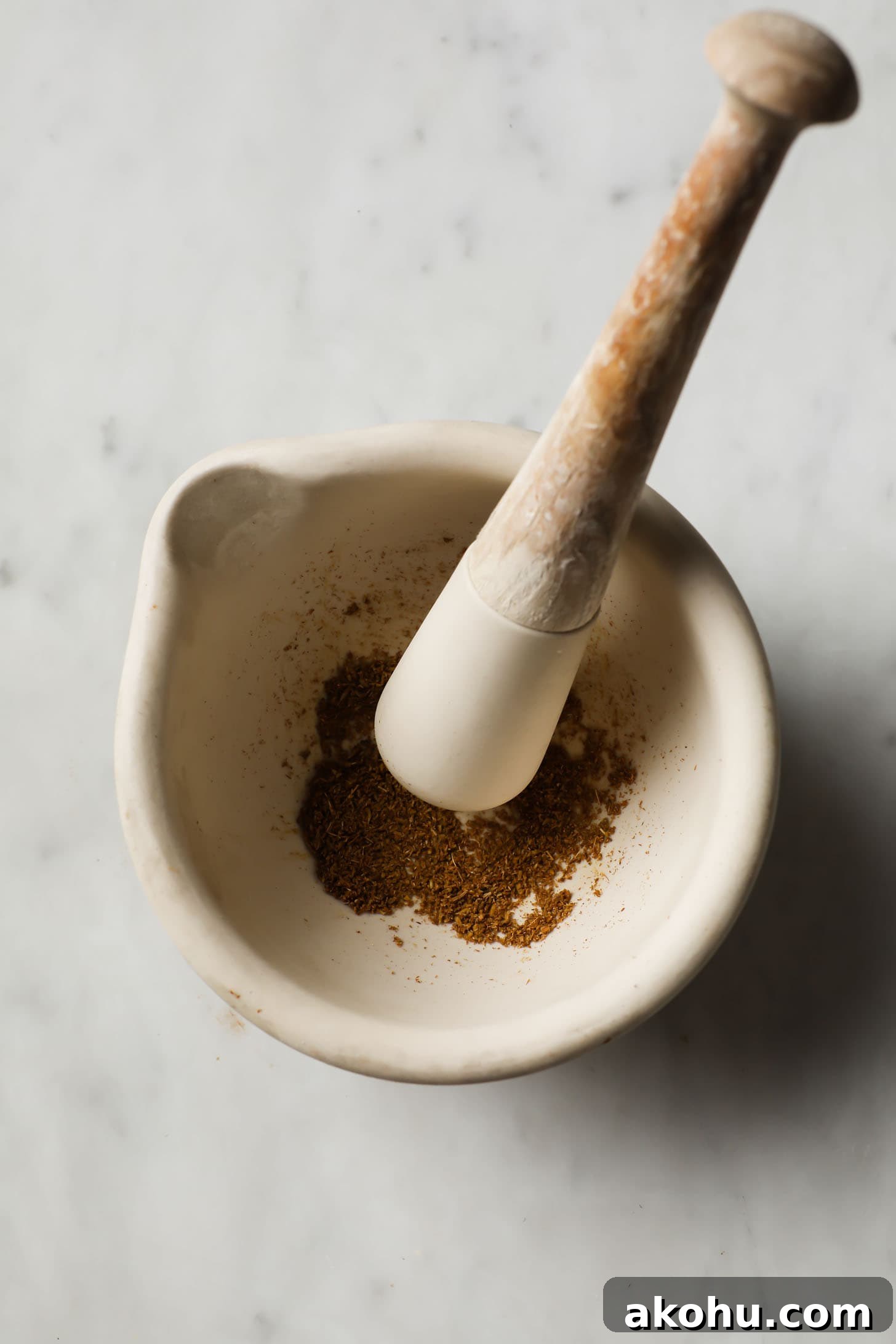 Ground cumin seeds in a mortar and pestle