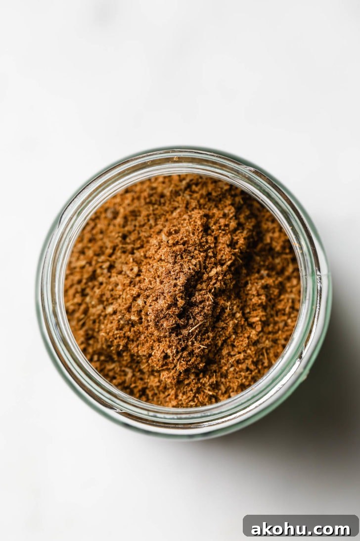 Top view of cumin powder in a glass jar.