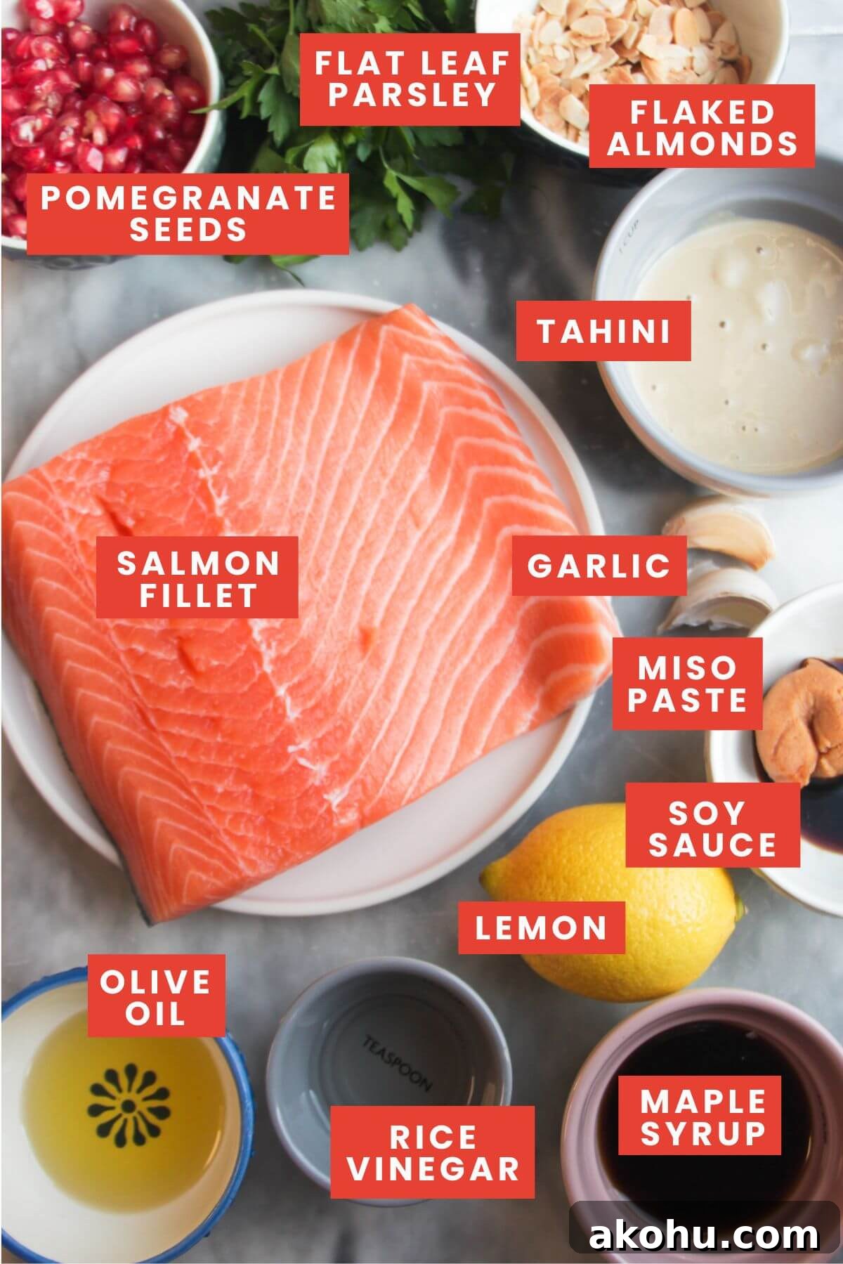 Ingredients for maple miso salmon on a grey marble background and labelled.