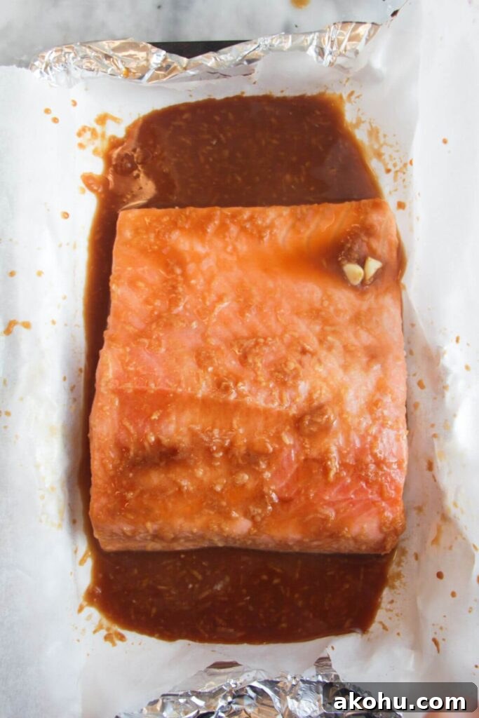 Maple miso glazed salmon fillet baked in a lined oven tray.