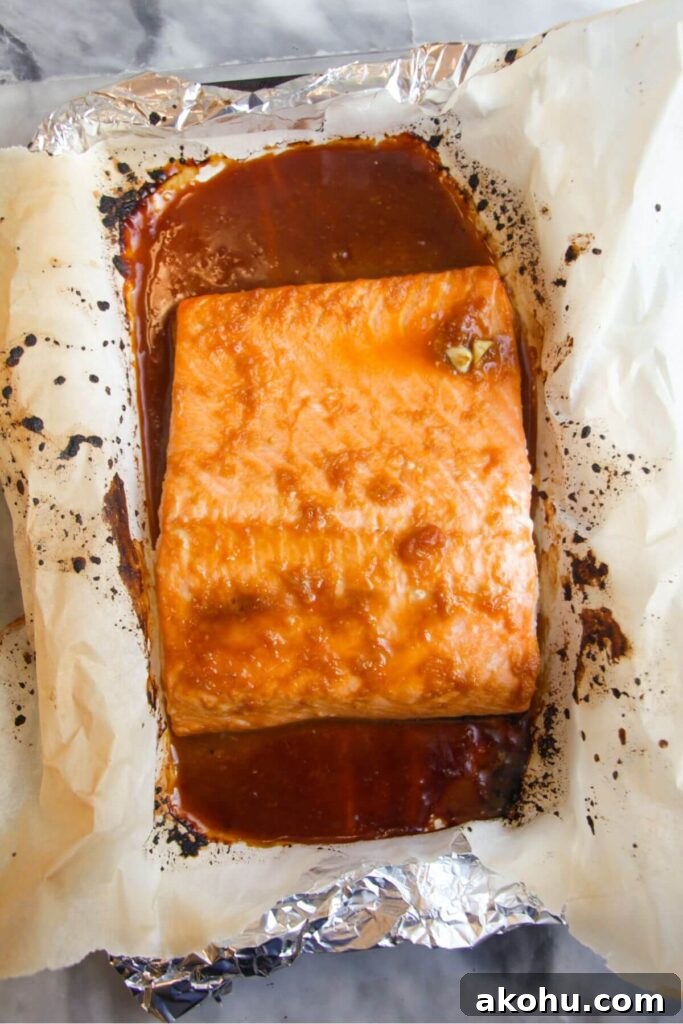 Maple miso salmon fillet grilled on a baking paper lined tray.