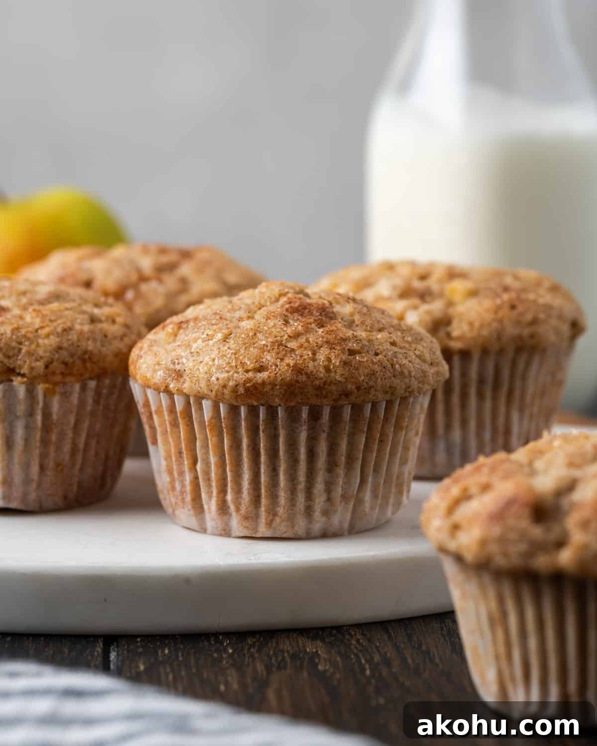 Apple Banana Muffins Recipe for Moist, Fluffy Bites 2 Apple banana muffins sitting on a marble cutting board.