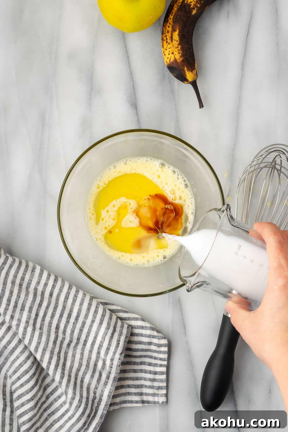 Apple Banana Muffins Recipe for Moist, Fluffy Bites 6 Oil, vanilla and non dairy milk added to a small mixing bowl with a beaten egg.