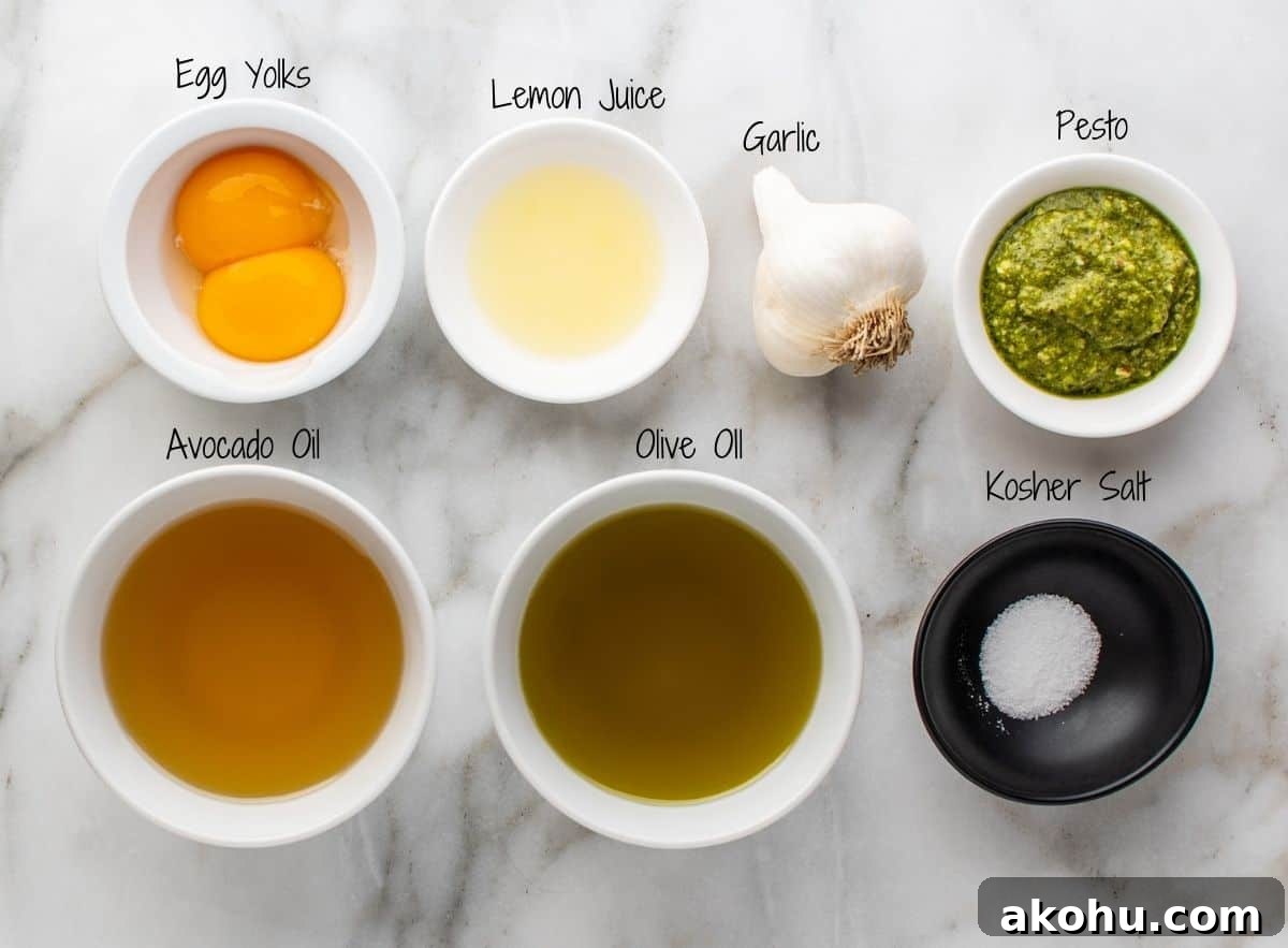 Creamy Pesto Aioli Recipe: Flavorful Sauce for Sandwiches & Dips 3 Pesto Aioli Ingredients on a white marble board.