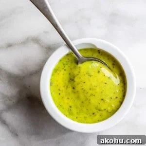 Creamy Pesto Aioli Recipe: Flavorful Sauce for Sandwiches & Dips 4 Pesto Aioli in a white bowl with a spoon in it