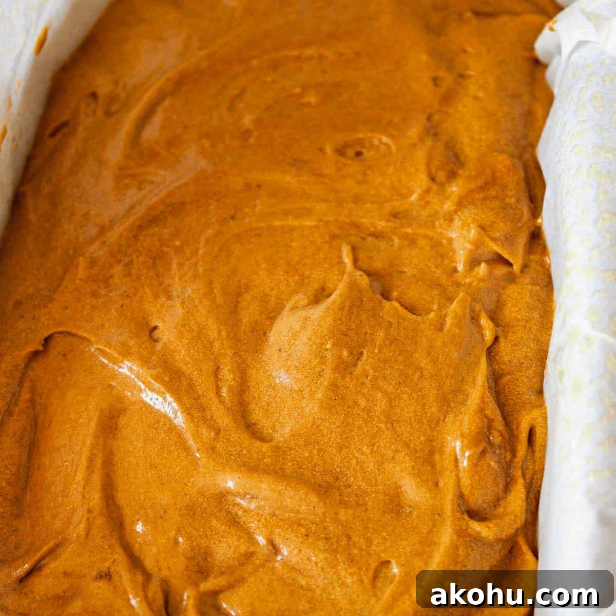Gingerbread batter in a loaf pan ready to be baked.