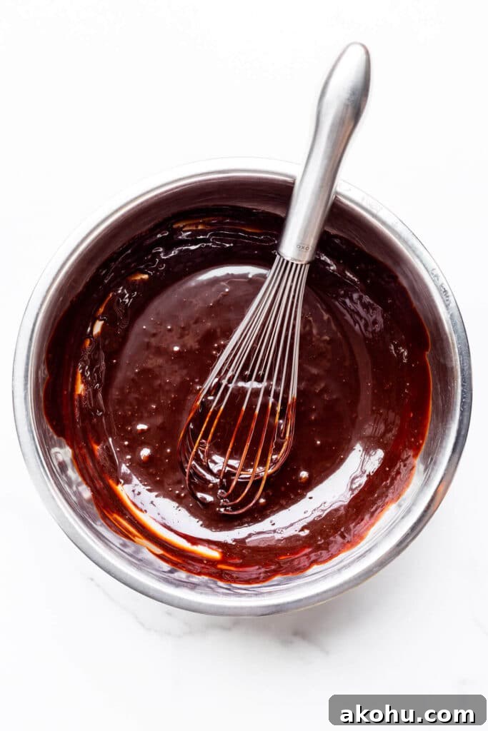 A bowl of homemade chocolate fudge sauce for sundaes and banana splits.