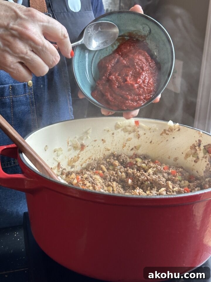 Savory Sloppy Joe Sliders with Tangy BBQ Sauce 5 adding tomato puree