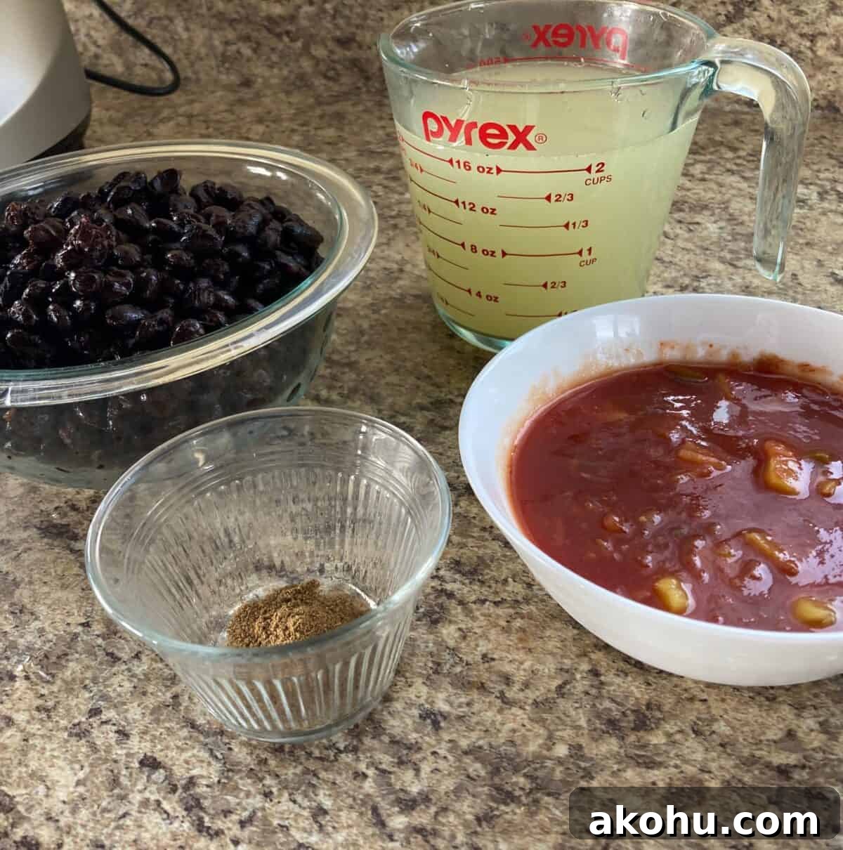 Black Bean Soup ingredients including black beans, broth, cumin and fruit salsa.
