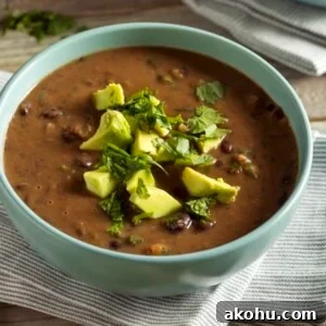 Homemade Black Bean Soup in a Green Bowl with Avocado and Cilantro