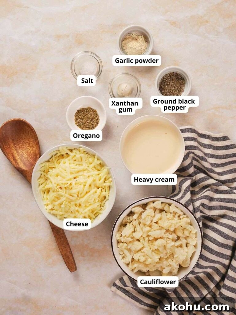 Keto Cauliflower Mac and Cheese: 4-Step Low-Carb Recipe 3 Ingredients for keto cauliflower mac and cheese are laid out on a countertop.