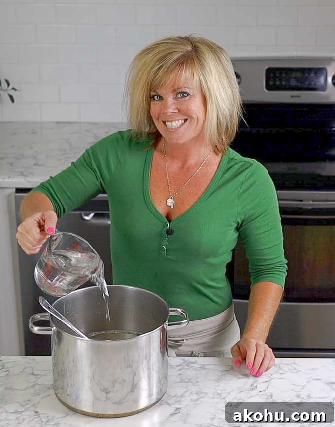 Turkey and Chicken Brine Recipe for Juicy, Flavorful Poultry 6 Jennifer poring water into a stock pot for brine
